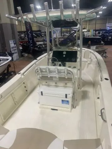 Slide: The Image of 2025 Bulls Bay 230CC boat interior at a showroom, featuring center console and seating. - 5