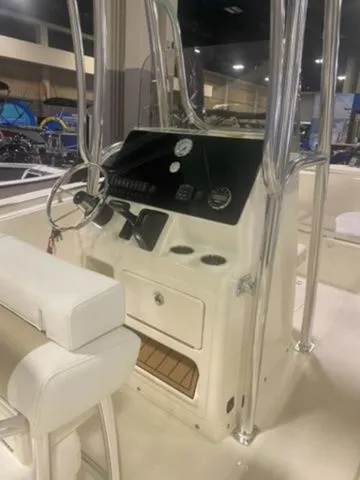 Slide: The Image of 2025 Bulls Bay 230CC boat interior with steering console and seating. - 6