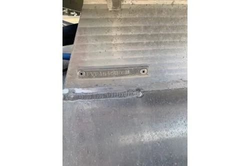 Slide: The Image of 2011 Fiesta 20' Fundeck Classic boat hull with visible identification plate. - 2