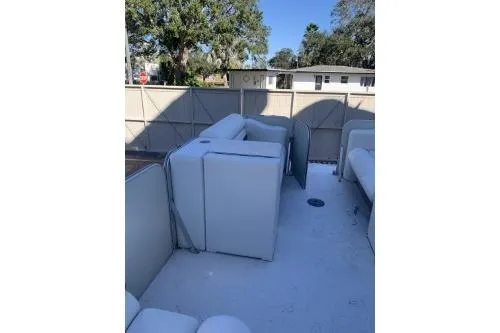 Slide: The Image of 2011 Fiesta 20' Fundeck Classic boat interior with white seating and open deck space. - 5