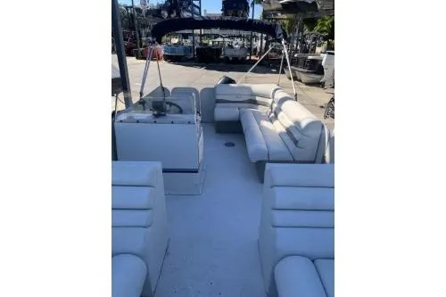 Slide: The Image of 2011 Fiesta 20' Fundeck Classic boat with spacious seating and canopy, docked outdoors. - 7