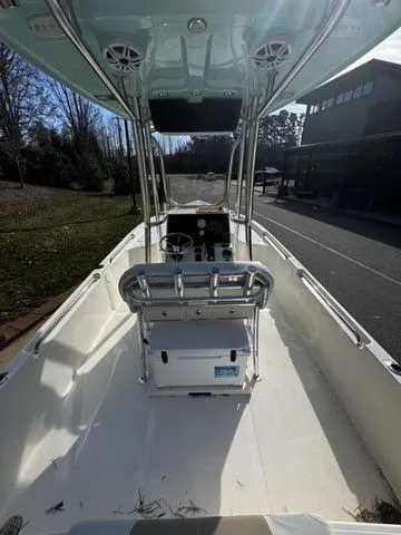 Slide: The Image of 2025 Bulls Bay 2400 boat interior with console and seating, parked outdoors. - 4