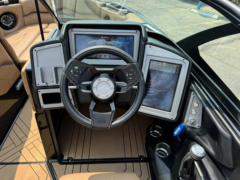 Slide: The Image of 2019 Supra SL450 boat dashboard with steering wheel and digital displays. - 12