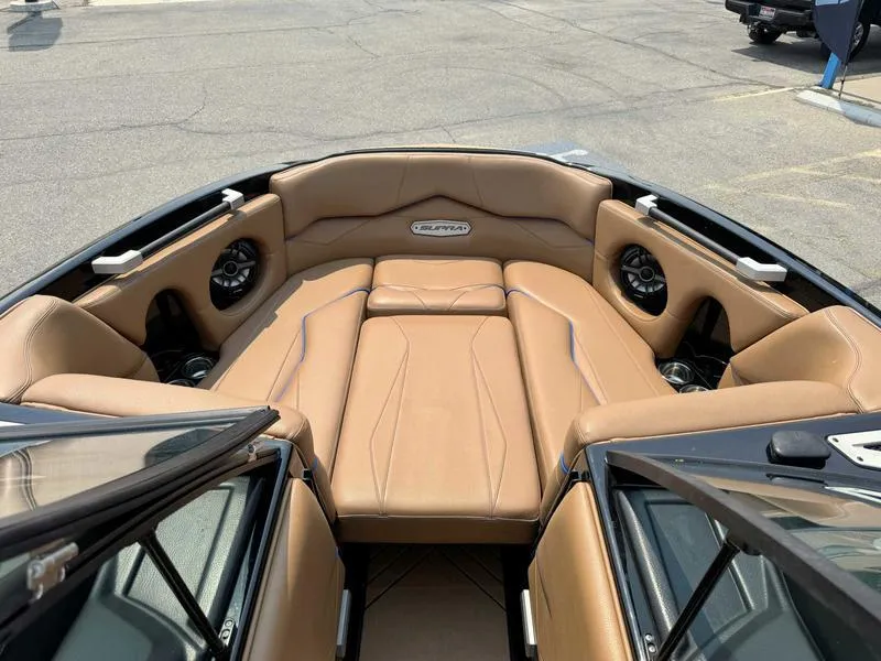 Slide: The Image of 2019 Supra SL450 boat interior with tan leather seating and built-in speakers. - 13
