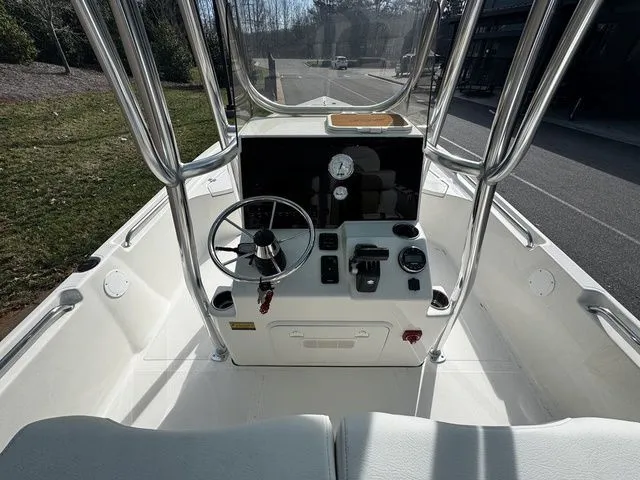 Slide: The Image of 2025 Bulls Bay 2400 boat console with steering wheel and controls, parked outdoors. - 5