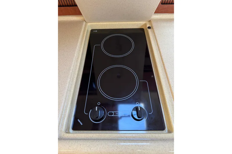 Slide: The Image of Stovetop in 2002 Sea Ray 310 Sundancer boat kitchen, featuring dual burners. - 15