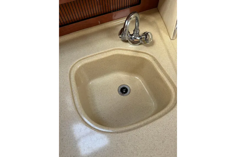 Slide: The Image of Beige sink with chrome faucet in 2002 Sea Ray 310 Sundancer boat. - 16