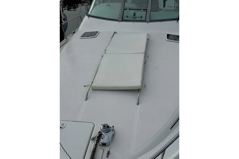 Slide: The Image of 2002 Sea Ray 310 Sundancer boat deck with sun pad and anchor. - 22