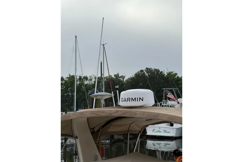 Slide: The Image of 2002 Sea Ray 310 Sundancer with Garmin radar, docked near other boats. - 27