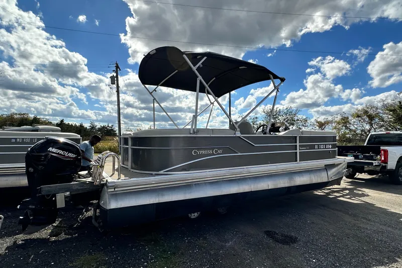Slide: The Image of 2022 Cypress Cay Seabreeze 232 pontoon boat with canopy, parked outdoors. - 3