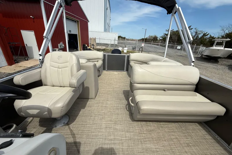 Slide: The Image of 2022 Cypress Cay Seabreeze 232 pontoon boat interior with beige seating and canopy. - 4