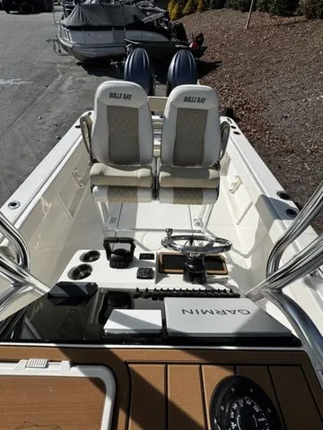 Slide: The Image of 2025 Bulls Bay 255CC boat interior with Garmin navigation system and dual seating. - 11