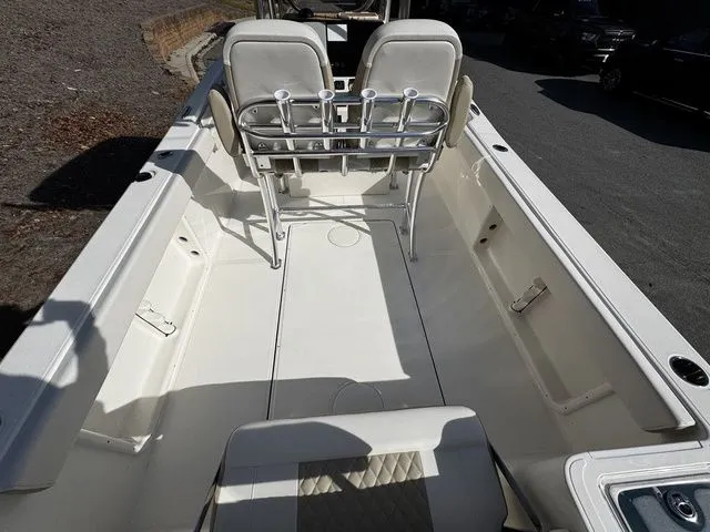Slide: The Image of 2025 Bulls Bay 255CC boat interior with dual seats and rod holders. - 5