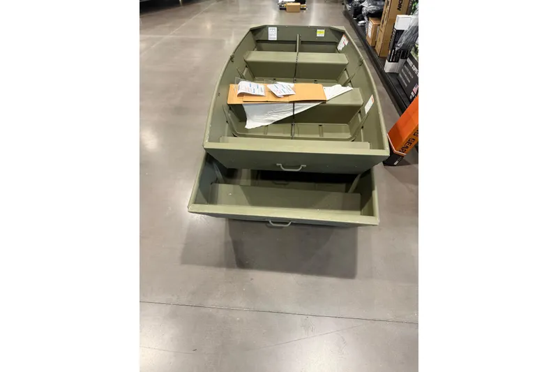 Slide: The Image of 2025 Crestliner 1436L CR Jon boat displayed in a store, showcasing its sturdy design. - 4