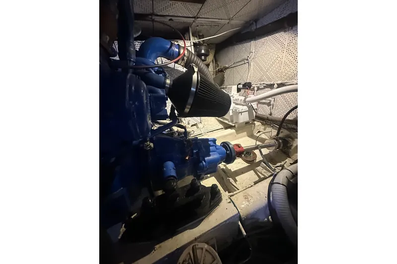Slide: The Image of Engine room of 1986 Lien Hwa 42 boat, featuring blue machinery and piping. - 12