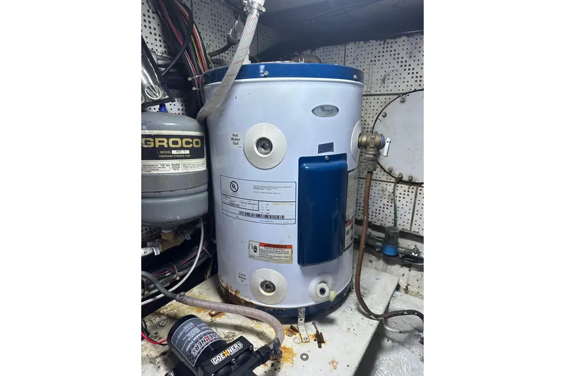 Slide: The Image of 1986 Lien Hwa 42 engine room with water heater and Groco pressure tank. - 15