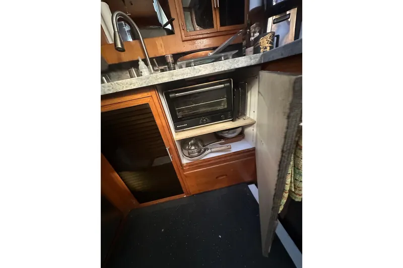 Slide: The Image of 1986 Lien Hwa 42 yacht kitchen with sink, toaster oven, and storage cabinets. - 18