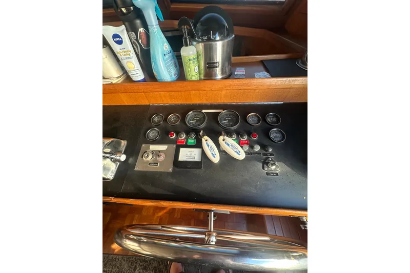 Slide: The Image of 1986 Lien Hwa 42 yacht control panel with gauges and cleaning supplies. - 19