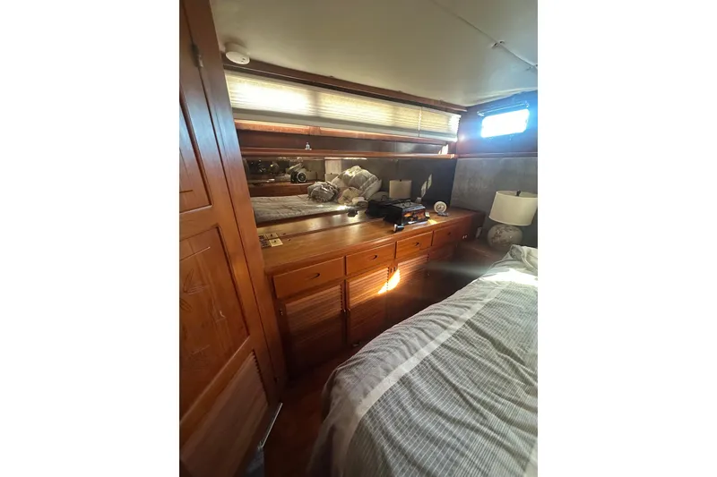 Slide: The Image of Cozy cabin interior of 1986 Lien Hwa 42 yacht with wooden furnishings and bed. - 32