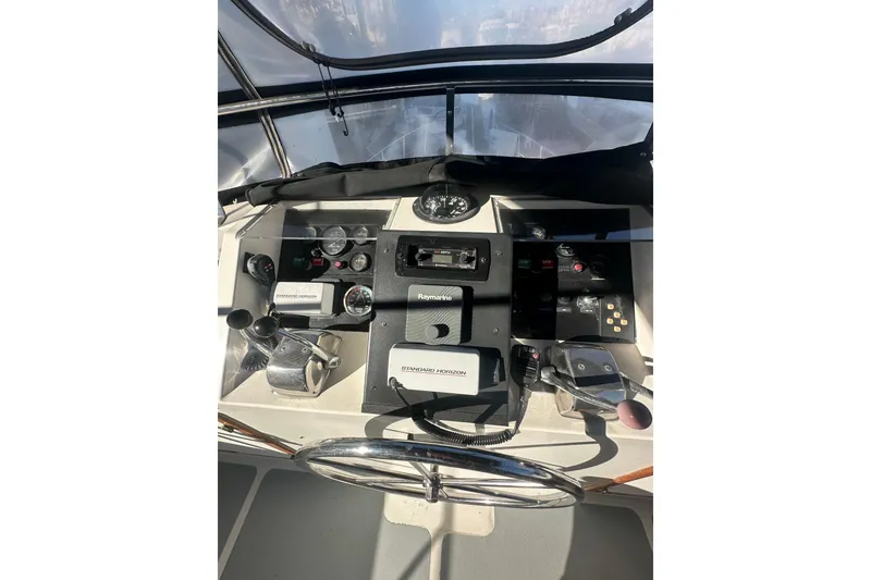 Slide: The Image of Helm of 1986 Lien Hwa 42 yacht with navigation instruments and steering wheel. - 8