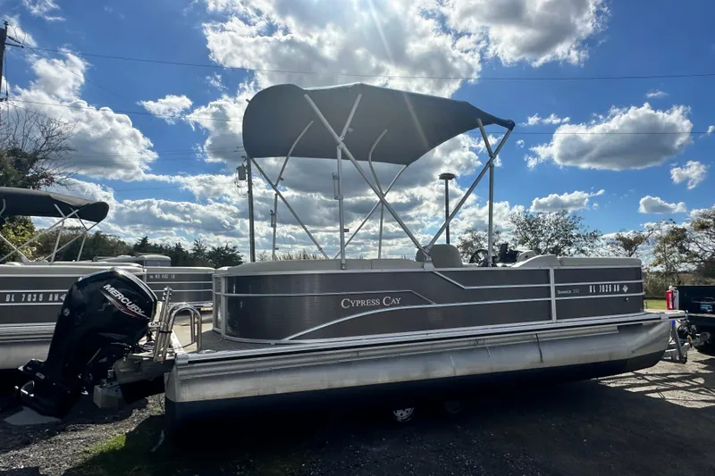 Slide: The Image of 2022 Cypress Cay Seabreeze 232 pontoon boat with canopy under a blue sky. - 3