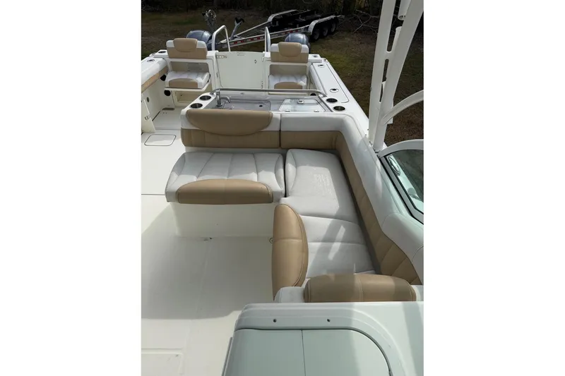 Slide: The Image of 2017 World Cat Glacier Bay Edition 2740 Dual Console boat interior with beige seating. - 11