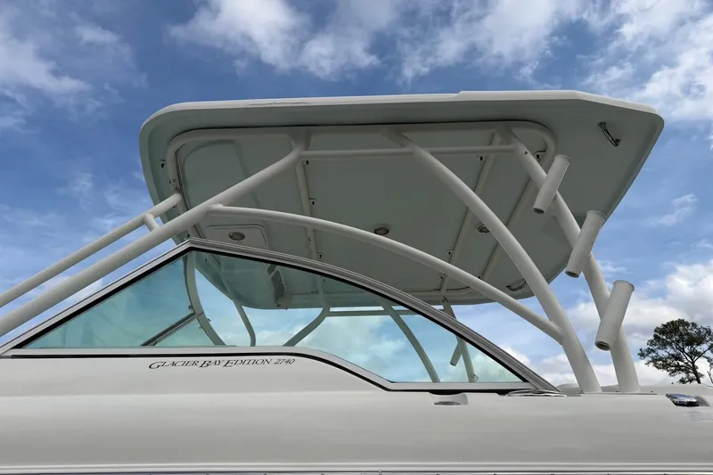 Slide: The Image of 2017 World Cat Glacier Bay Edition 2740 Dual Console boat under a blue sky. - 23