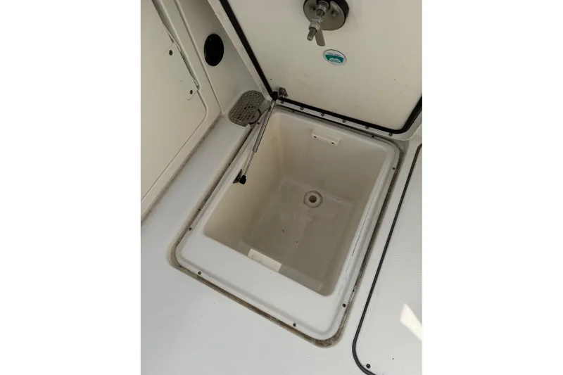 Slide: The Image of 2017 World Cat Glacier Bay Edition 2740 storage compartment, open lid, white interior. - 30