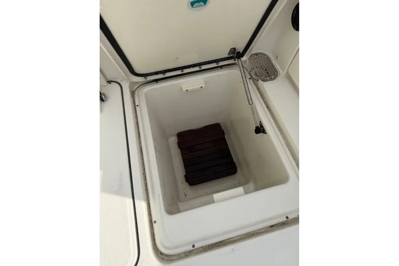 Slide: The Image of Open storage compartment on 2017 World Cat Glacier Bay Edition 2740 Dual Console boat. - 31