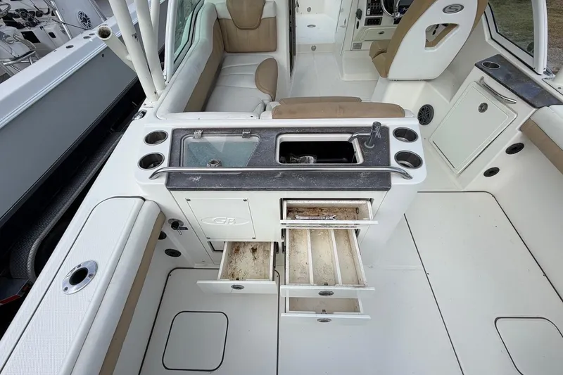 Slide: The Image of 2017 World Cat Glacier Bay Edition 2740 Dual Console interior with open storage and seating. - 39