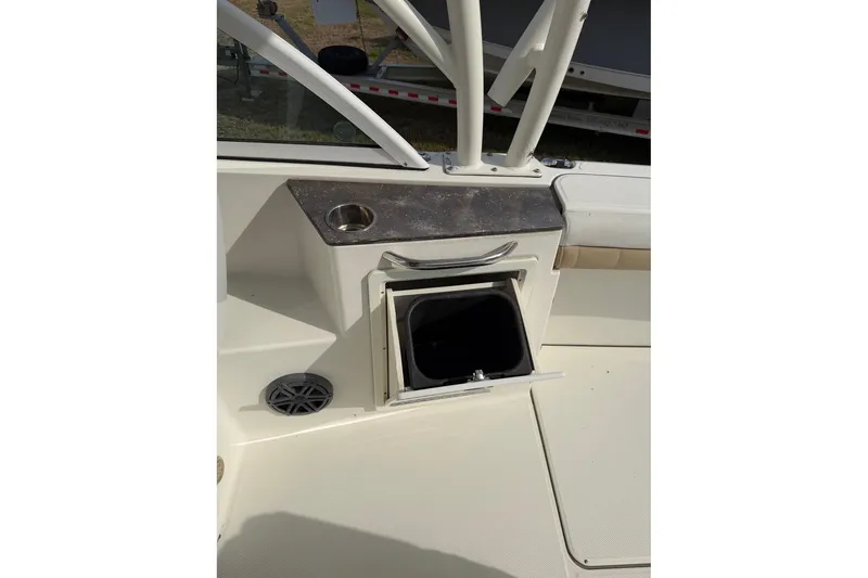 Slide: The Image of 2017 World Cat Glacier Bay Edition 2740 Dual Console interior with storage compartment. - 41