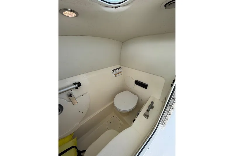 Slide: The Image of 2017 World Cat Glacier Bay Edition 2740 boat interior bathroom with toilet and compact design. - 47
