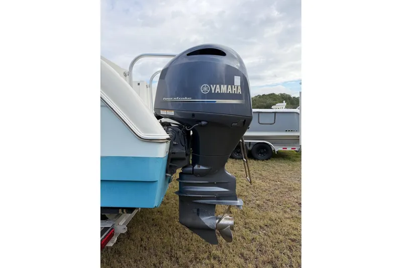 Slide: The Image of 2017 World Cat Glacier Bay Edition 2740 with Yamaha outboard motor, parked on grass. - 56