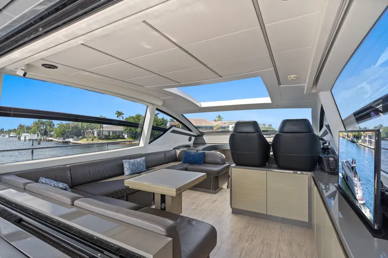 Slide: The Image of Luxurious interior of a 2016 Pershing 62' yacht with modern seating and scenic views. - 13