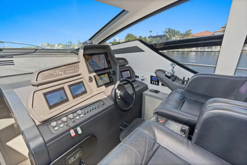 Slide: The Image of Cockpit of 2016 Pershing 62' yacht with advanced navigation systems and leather seating. - 16