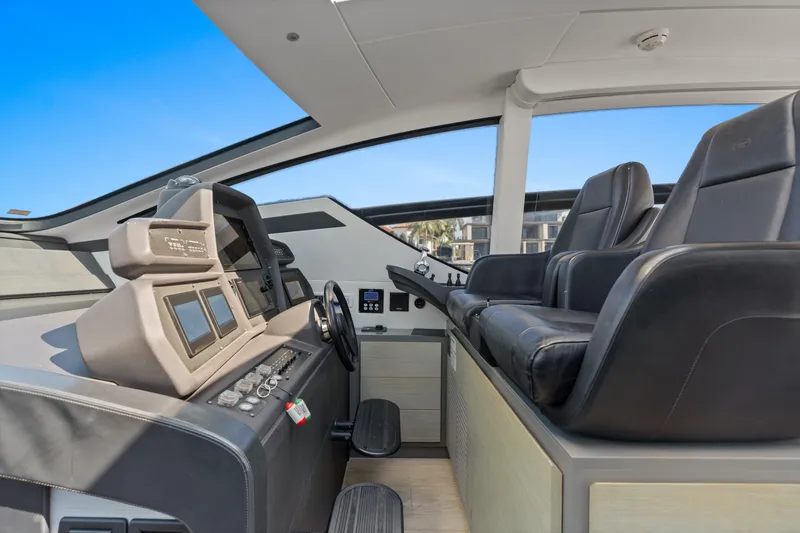 Slide: The Image of Interior helm of 2016 Pershing 62' yacht with modern controls and leather seating. - 17