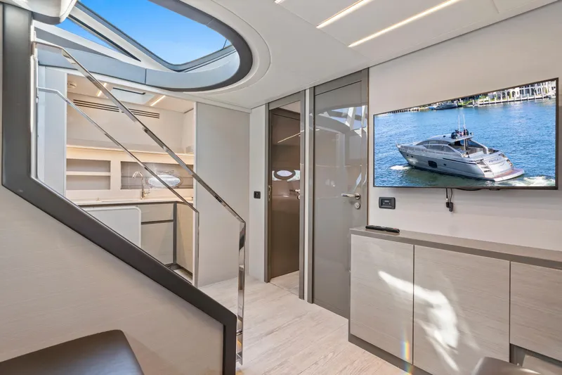 Slide: The Image of Luxurious interior of 2016 Pershing 62' yacht with modern design and TV display. - 19