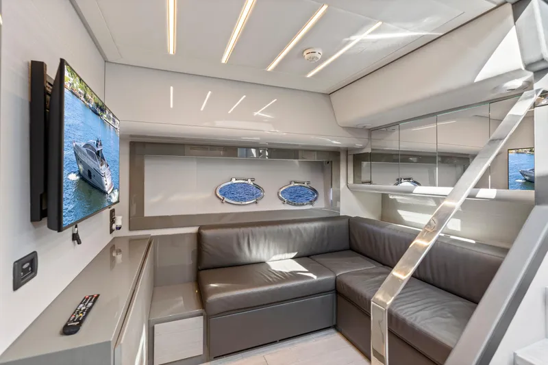 Slide: The Image of Luxurious interior of 2016 Pershing 62' yacht with modern seating and TV. - 21