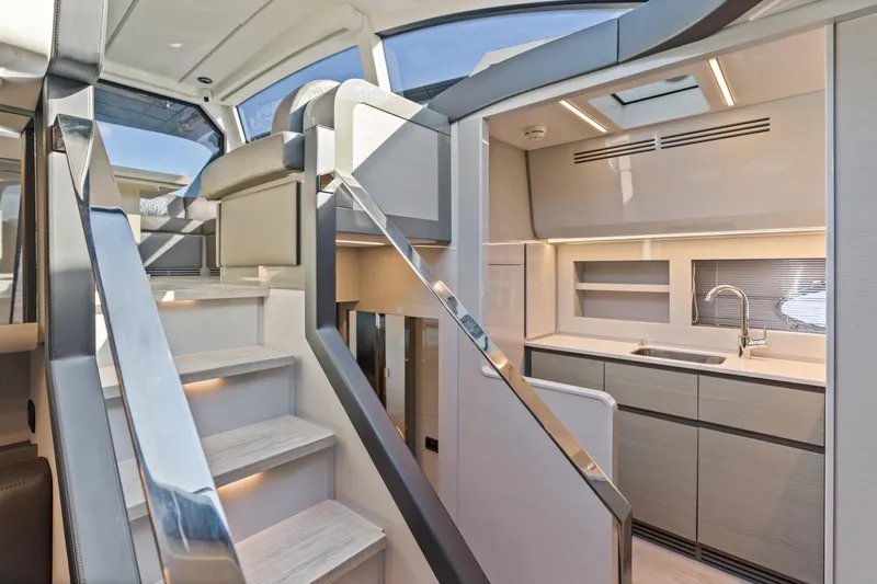Slide: The Image of Luxurious interior of 2016 Pershing 62' yacht with modern kitchen and sleek staircase. - 22