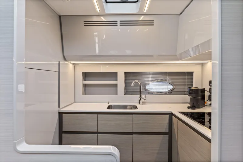 Slide: The Image of Modern kitchen interior of 2016 Pershing 62' yacht with sleek design and appliances. - 23