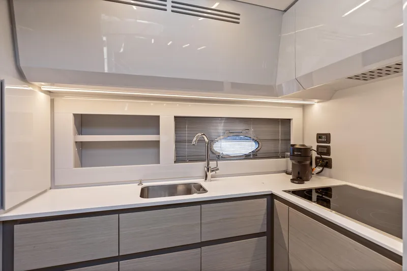 Slide: The Image of Modern kitchen interior of 2016 Pershing 62' yacht with sleek design and appliances. - 24