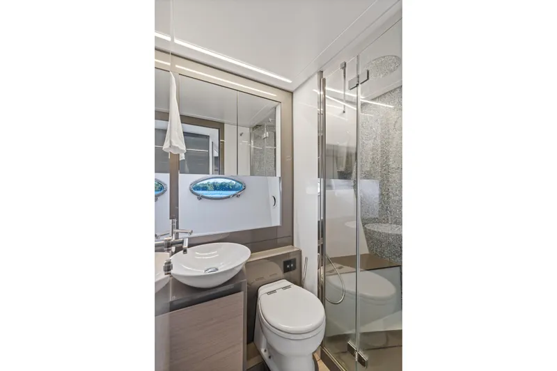 Slide: The Image of Luxurious bathroom on 2016 Pershing 62' yacht with modern fixtures and glass shower. - 30