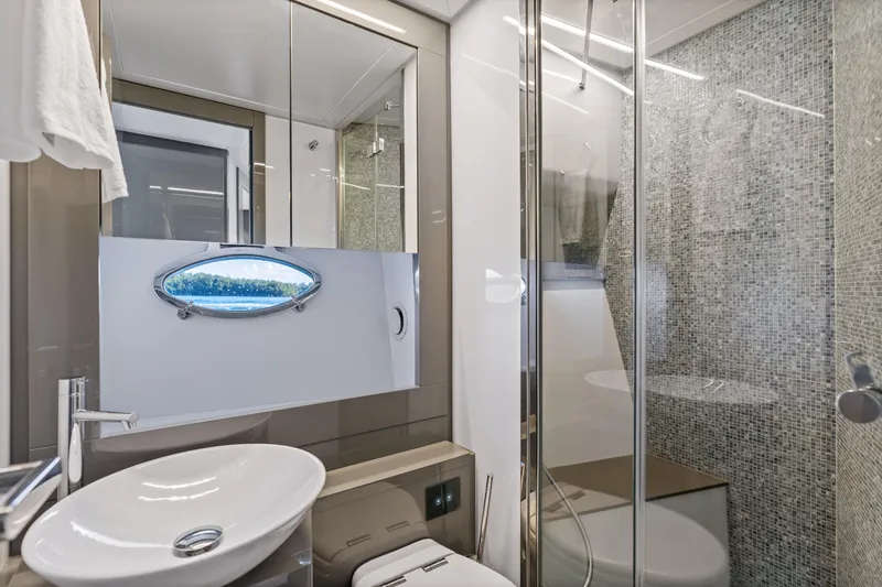 Slide: The Image of Luxurious bathroom in 2016 Pershing 62' yacht with modern fixtures and mosaic tiles. - 31