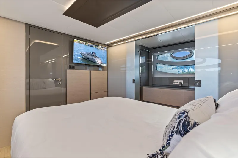 Slide: The Image of Luxurious interior of 2016 Pershing 62' yacht with modern bedroom and TV. - 33