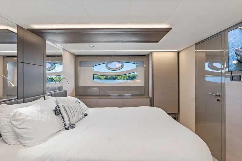 Slide: The Image of Luxurious bedroom interior of 2016 Pershing 62' yacht with modern design and window view. - 34