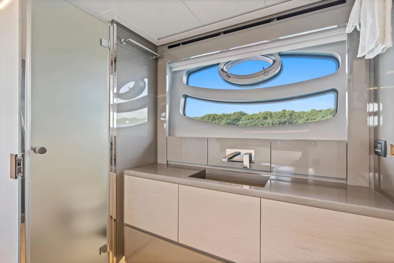 Slide: The Image of Luxurious bathroom interior of 2016 Pershing 62' yacht with modern fixtures and scenic window view. - 35