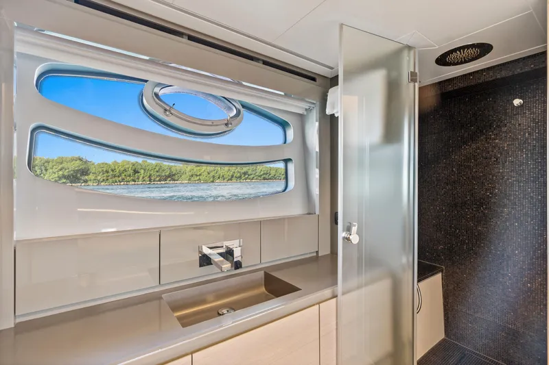 Slide: The Image of Luxurious bathroom interior of 2016 Pershing 62' yacht with scenic window view. - 36