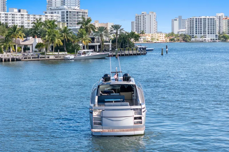 Slide: The Image of Luxury 2016 Pershing 62' yacht cruising near waterfront cityscape. - 4