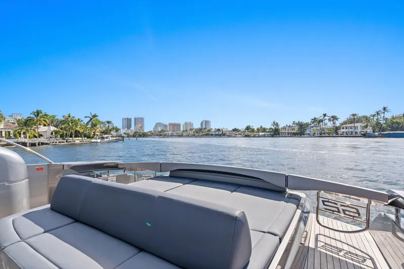 Slide: The Image of 2016 Pershing 62' yacht deck with waterfront view, palm trees, and clear blue sky. - 9
