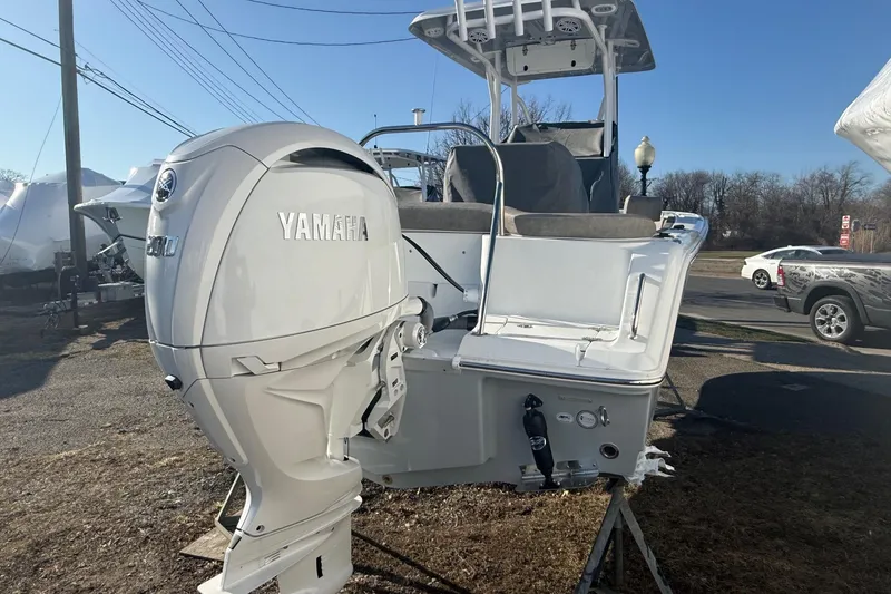 Slide: The Image of 2026 Sea Hunt Ultra 229 boat with Yamaha engine, parked outdoors. - 10
